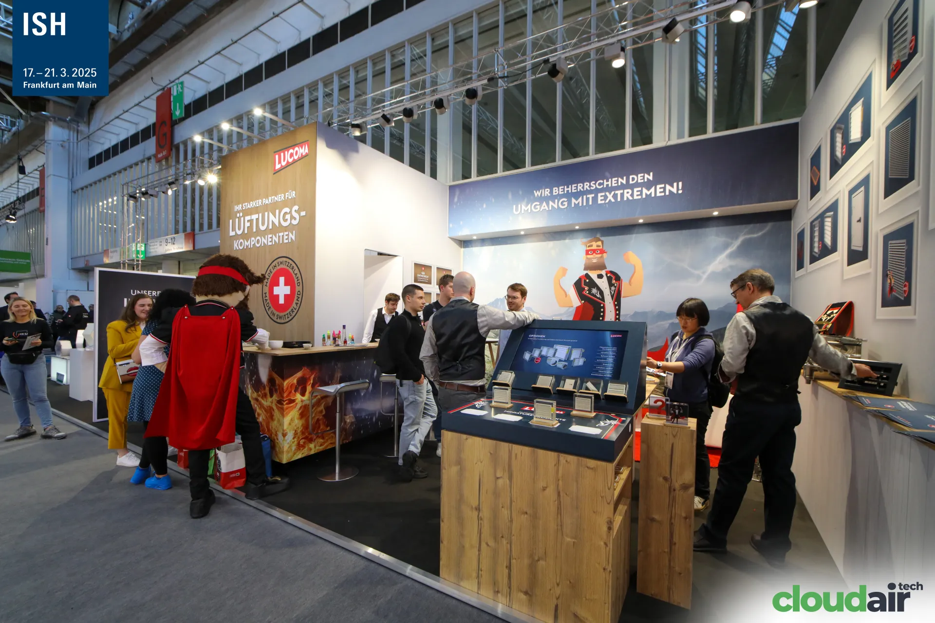 Full view of the Lucoma stand with mascot, bar and product kiosk at ISH 2025