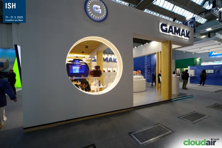 Gamak stand facade with illuminated logo and a round window