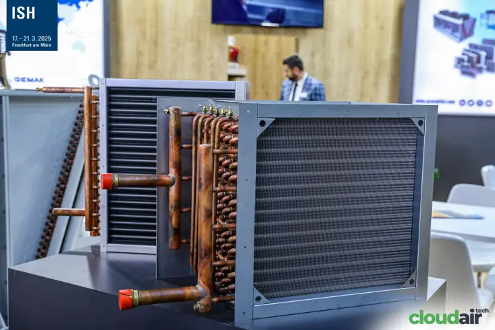 Gemak finned copper-tube coils with red-capped headers on a display plinth at ISH 2025