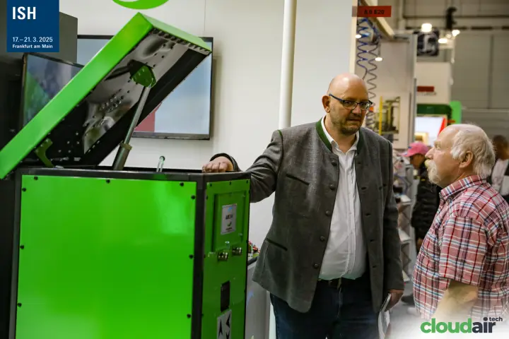 Green equipment cabinet with raised lid shown to visitors near hall 8.0