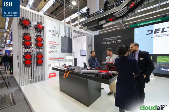 Heatpex ARIA Vitale Compact unit poster beside red distribution manifolds at ISH 2025