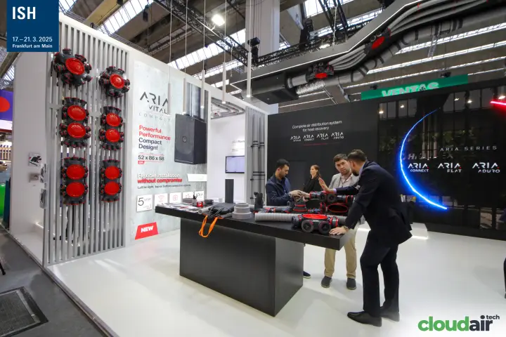 Heatpex staff demonstrate ARIA fittings in front of the ARIA Series screen at ISH 2025