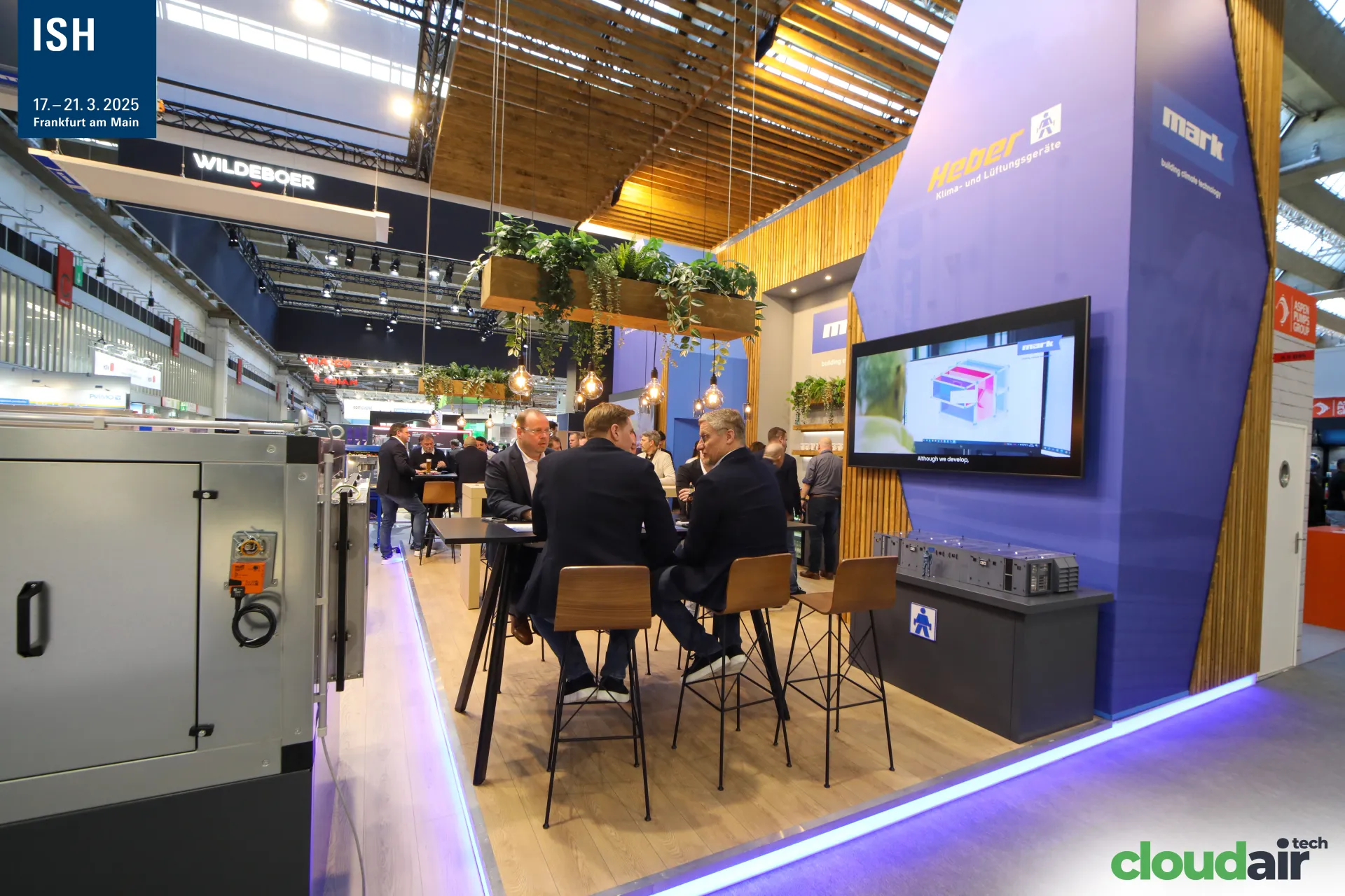 Heber and Mark meeting area under a wooden slat ceiling at ISH 2025