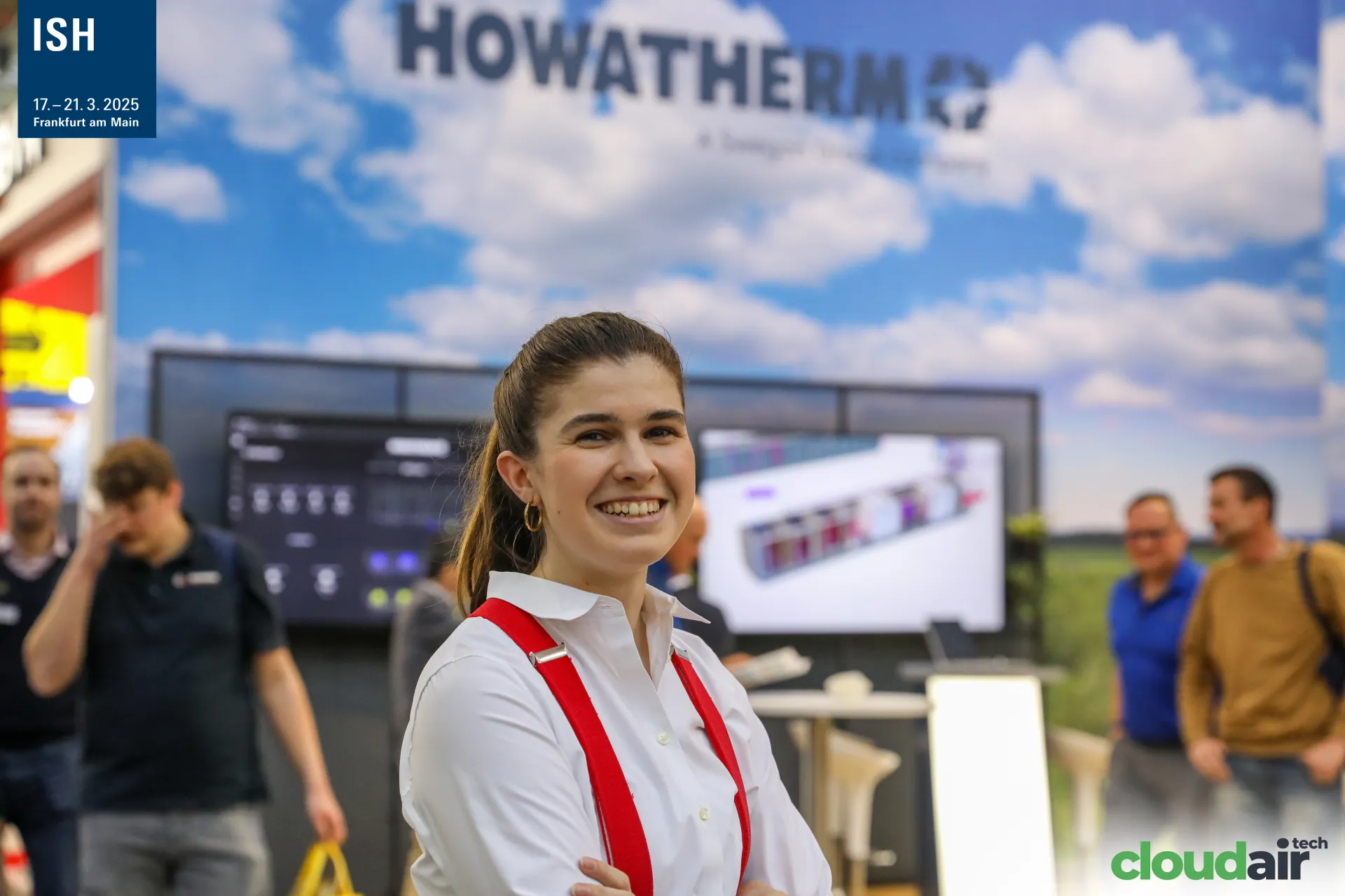 Howatherm team member in front of the sky-themed stand wall at ISH 2025