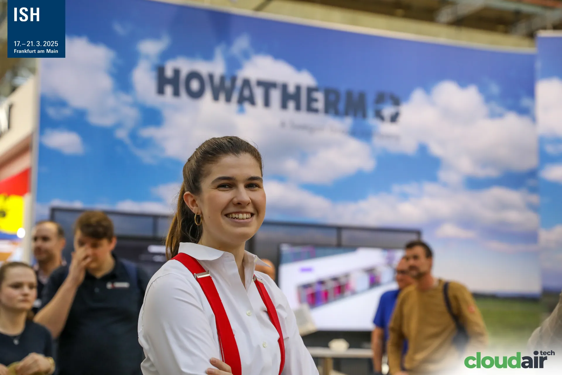 Howatherm team member with the logo backdrop at ISH 2025