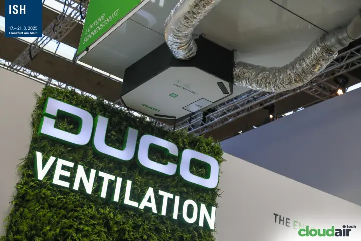 Illuminated Duco Ventilation sign on a green wall below a ceiling unit at ISH 2025