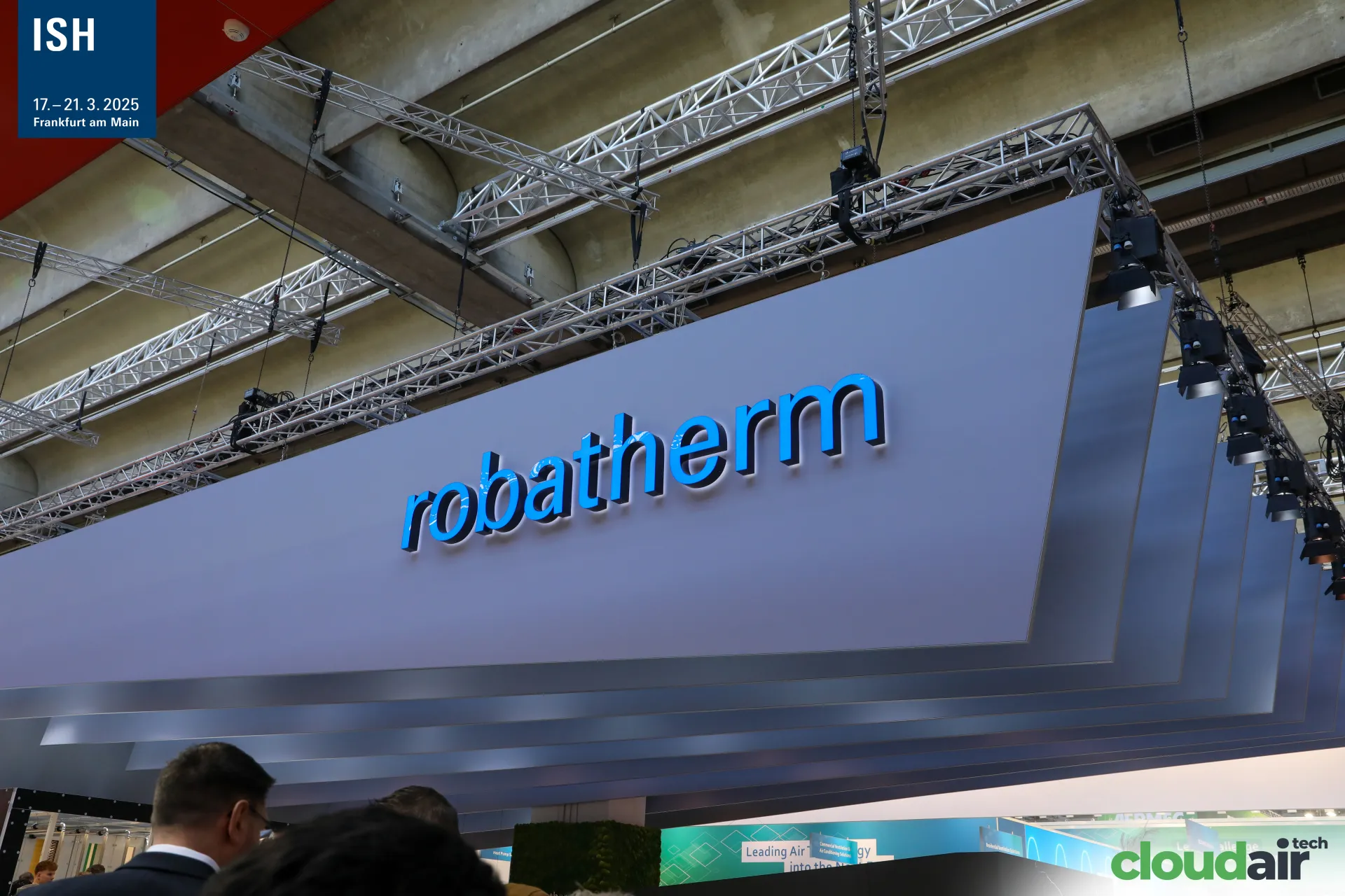 Illuminated robatherm logo on a suspended layered canopy at ISH 2025