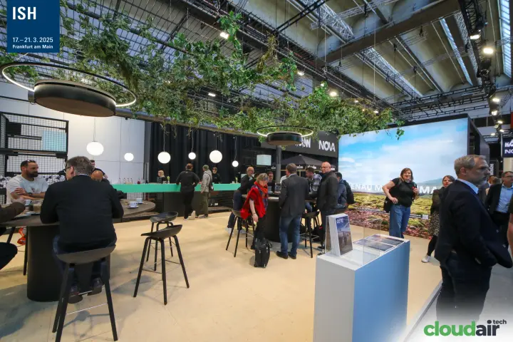 Kampmann bar and meeting tables under a canopy of hanging plants at ISH 2025