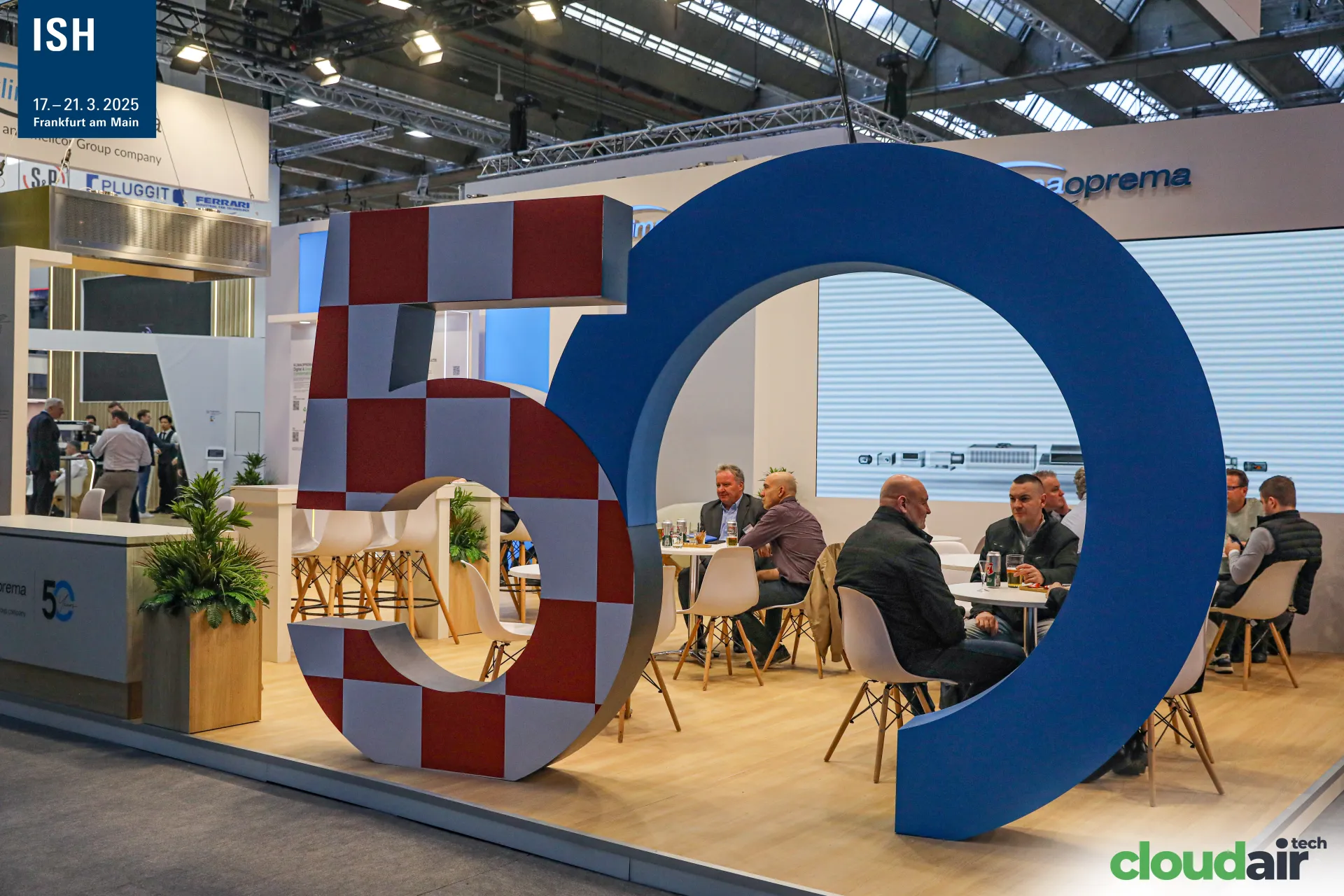 Klimaoprema lounge framed by a giant red-and-white checkered 50 at ISH 2025