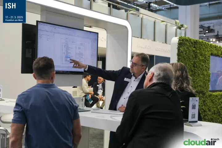 Linear staff explaining a CAD floor plan to visitors at ISH 2025
