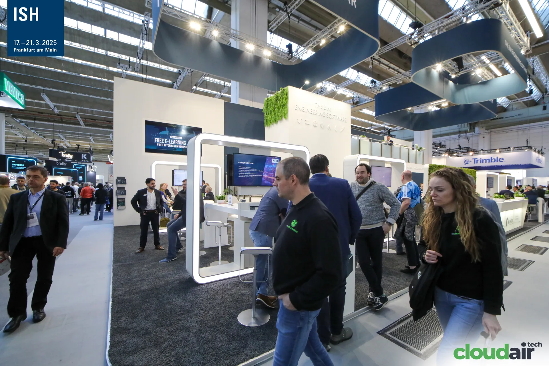 Linear stand seen from the aisle with e-learning and electrical design screens at ISH 2025