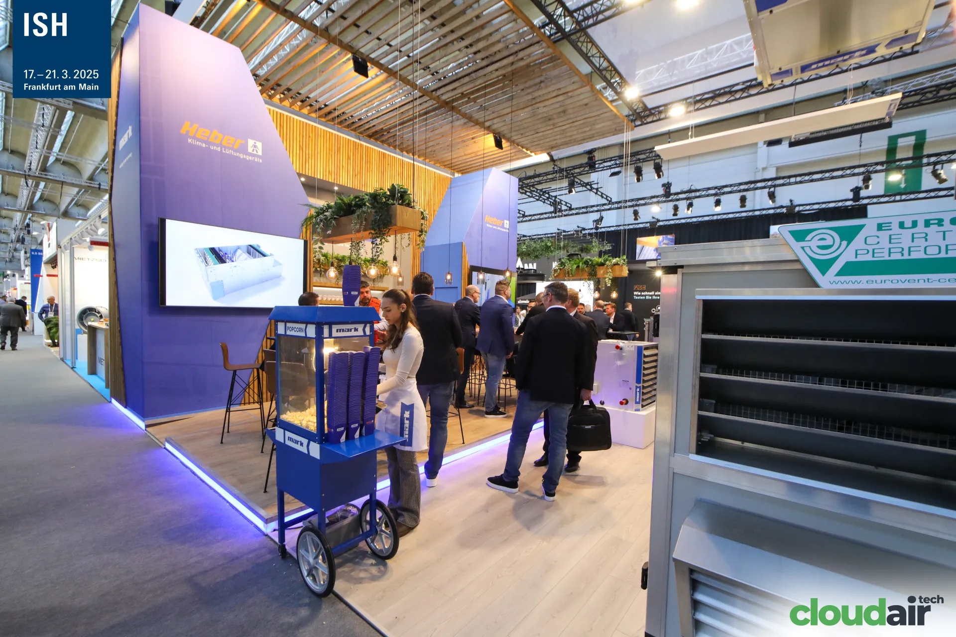 Mark stand with Heber branding, popcorn cart and a rooftop unit at ISH 2025