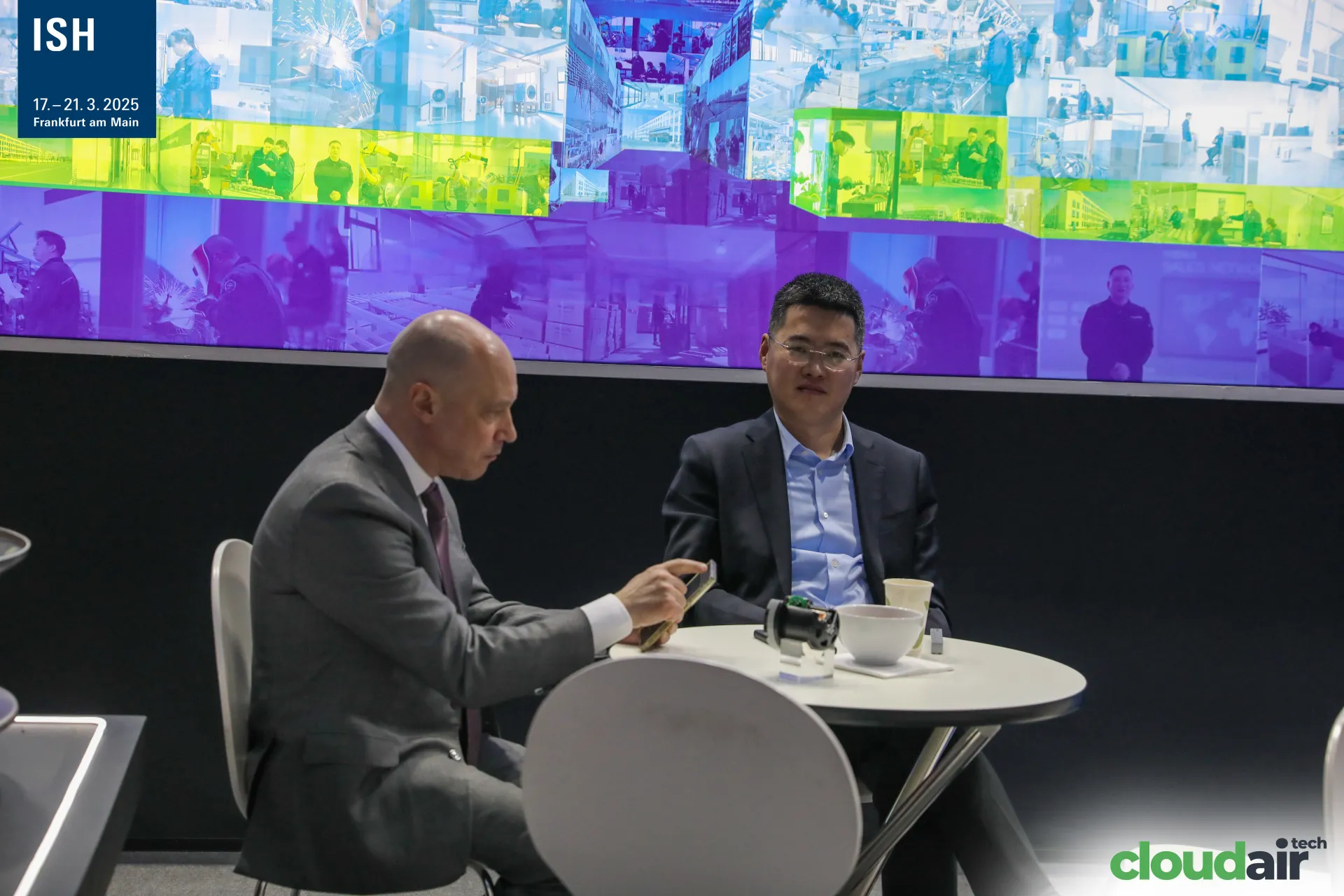 Meeting at a Bayoung table below the factory video wall at ISH 2025