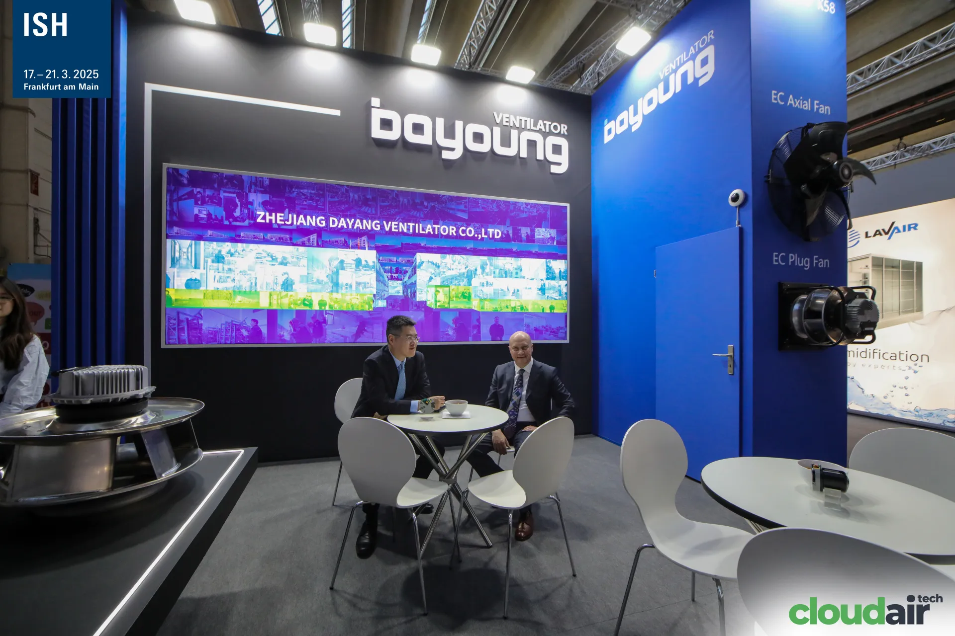 Meeting table under the Bayoung video wall with EC fans on display at ISH 2025