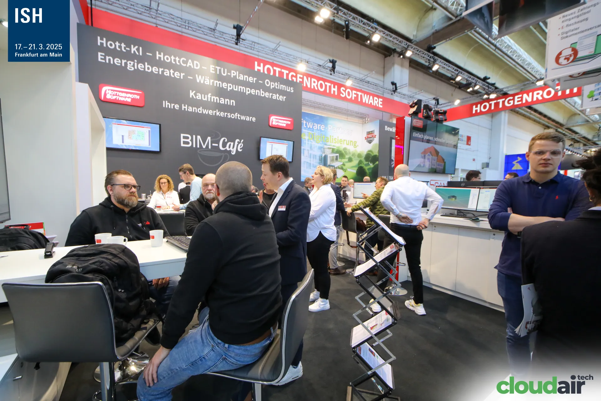 Meeting tables in front of the Hottgenroth BIM-Café wall at ISH 2025