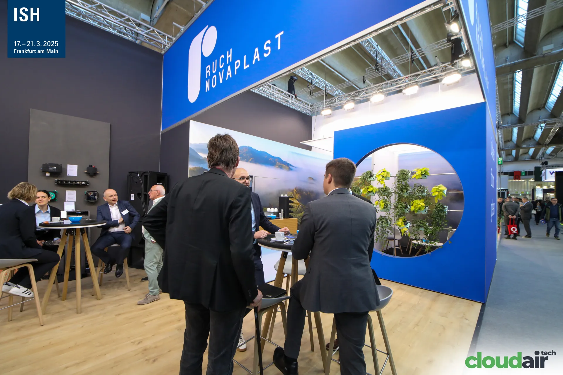 Meeting tables under the blue Ruch Novaplast fascia at ISH 2025