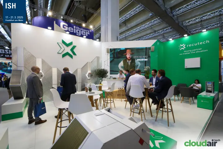 Meetings at high tables on the green and white Recutech stand
