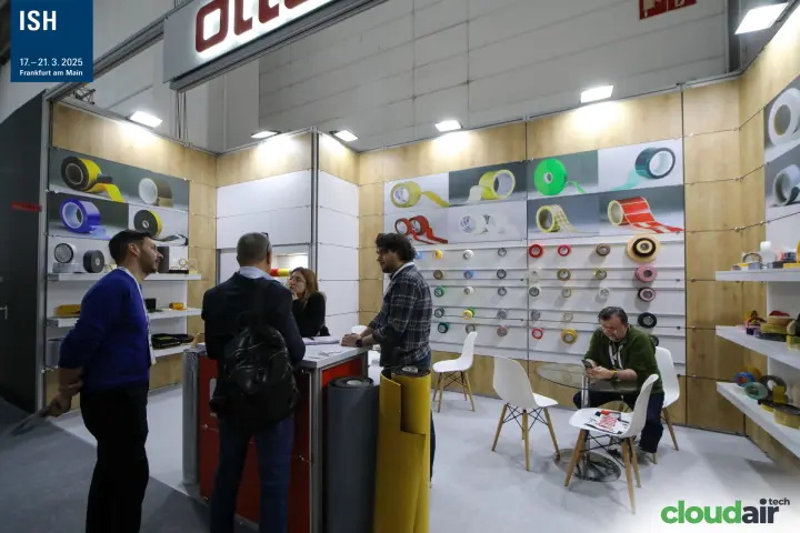 Otte adhesive tape display wall with visitors at the red counter at ISH 2025