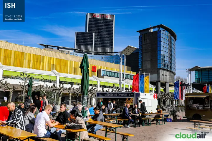 Outdoor food court with beer benches in front of Hall 5