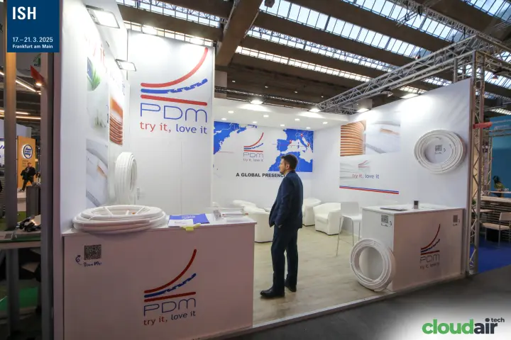 PDM stand with coils of pre-insulated pipe and a world map at ISH 2025
