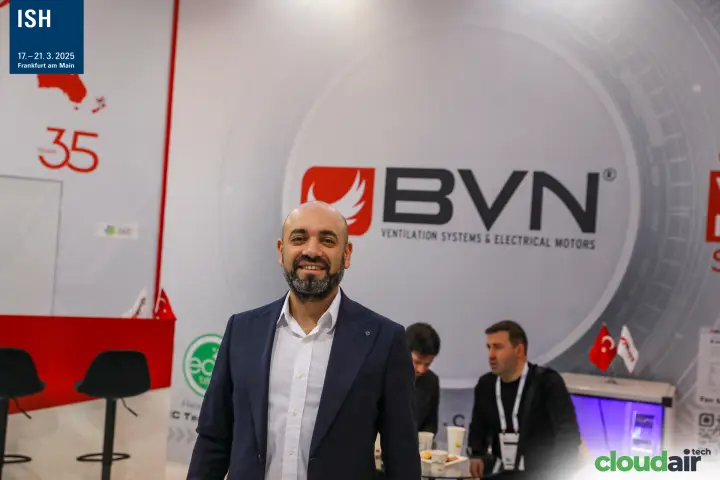Portrait at the BVN stand in front of the company logo wall