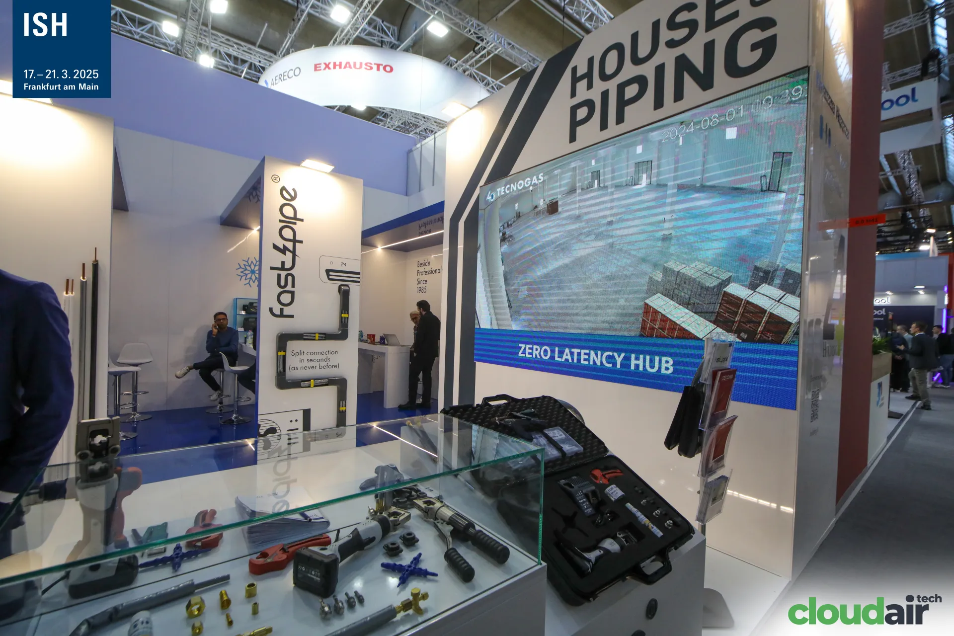 Pressing tools and fittings in a glass case under the "Zero Latency Hub" screen at ISH 2025