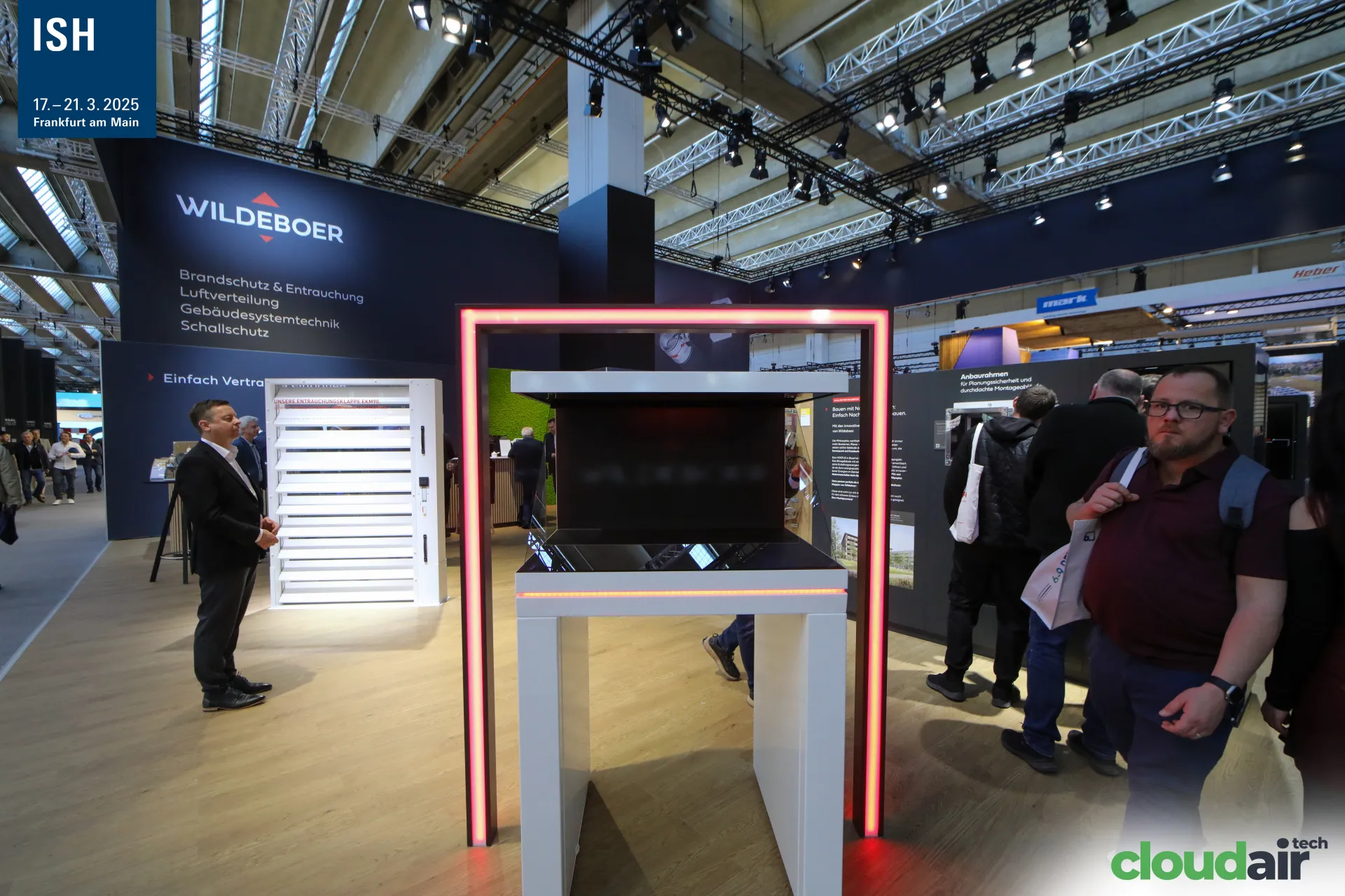 Red-lit display frame and EKM90 smoke damper on the Wildeboer stand at ISH 2025