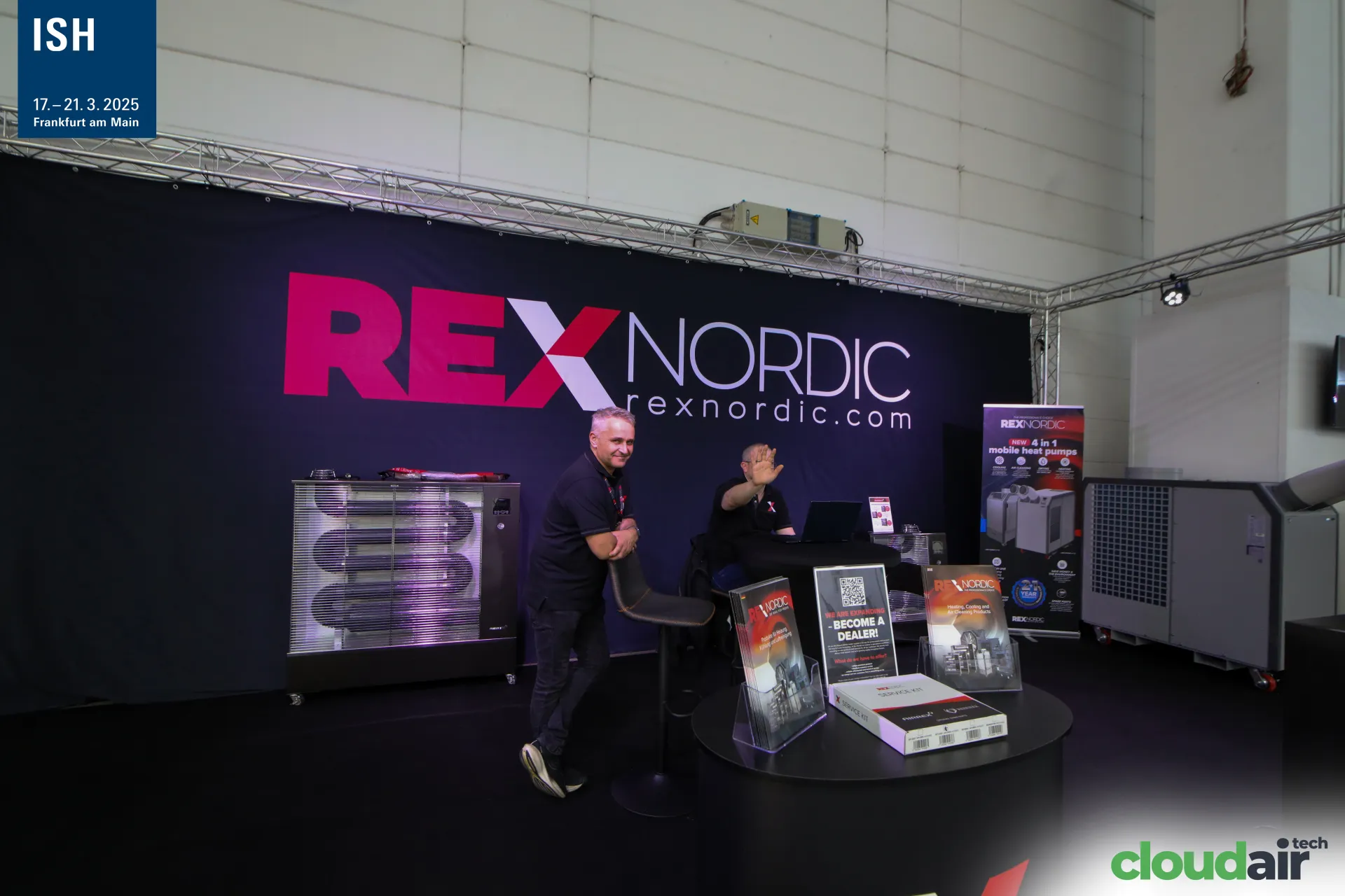 Rex Nordic staff with "Become a Dealer!" flyers and radiant heater at ISH 2025
