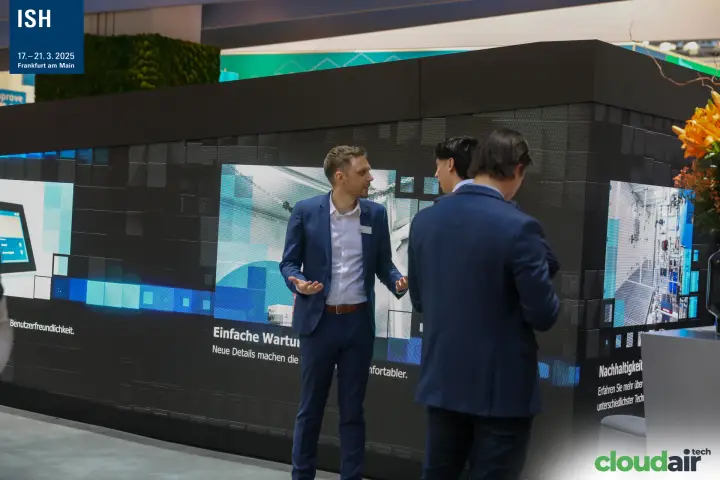 Robatherm staff with visitors in front of the stand's LED video wall at ISH 2025