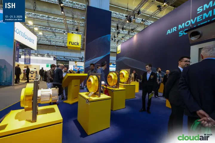 Ruck fan with exposed motor in front of a row of yellow-impeller fans at ISH 2025
