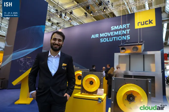 Ruck staff member beside the yellow plug fan display at ISH 2025