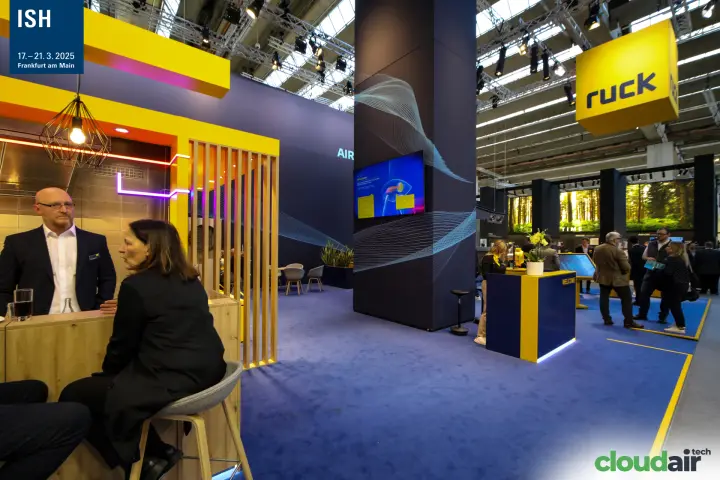 Ruck stand bar corner, wave-graphic pillar and suspended yellow logo cube at ISH 2025