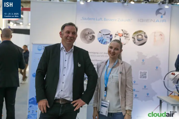 Smiling Igienair staff at their duct hygiene stand