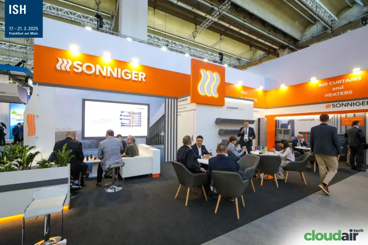 Sonniger stand with orange fascia and busy meeting area at ISH 2025