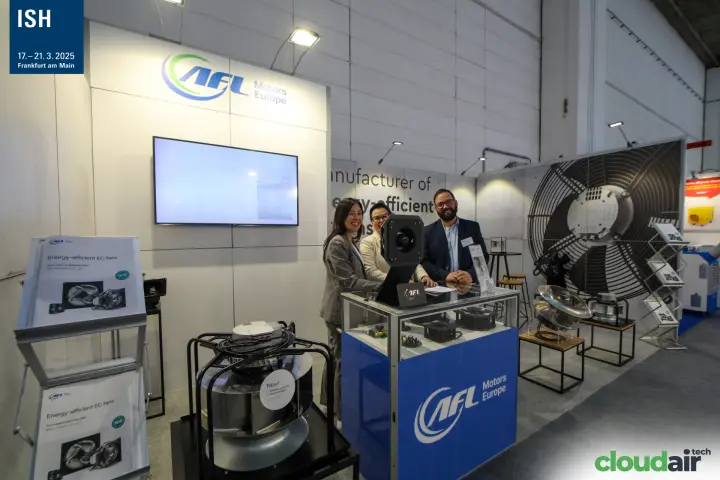 Staff behind the AFL Motors Europe counter with a new plug fan in front at ISH 2025