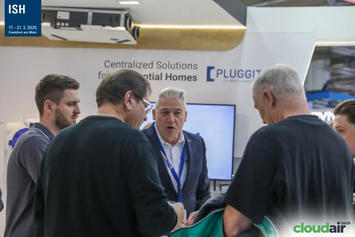 Staff member explains to visitors at the Pluggit stand at ISH 2025