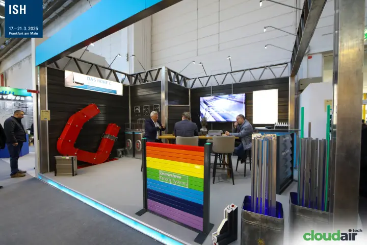 Stand with large red C-shaped element and rainbow fencing panel