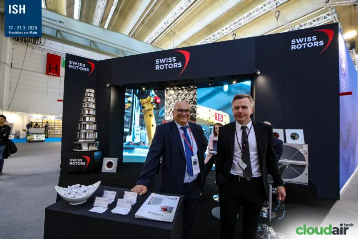 Swiss Rotors staff with impeller tower and robot footage on screen