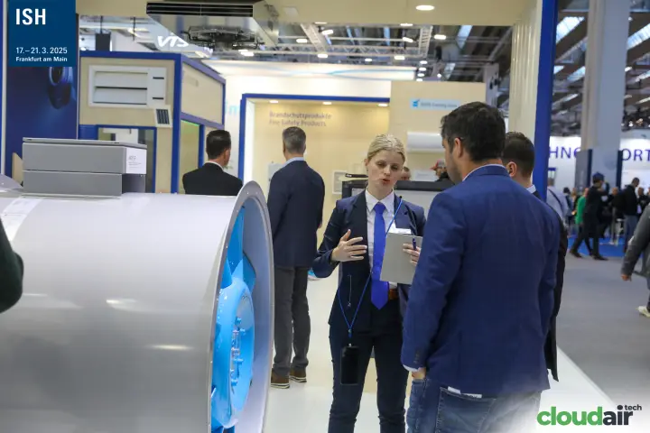 Systemair staff explaining an axial fan to visitors