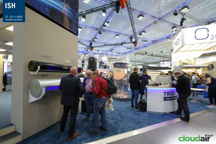 TROX stand with wall-mounted cylindrical units and illuminated reception counter at ISH 2025