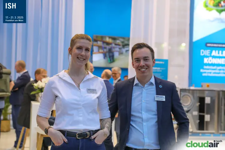 Two Airflow staff members on the stand with blue graphics behind at ISH 2025