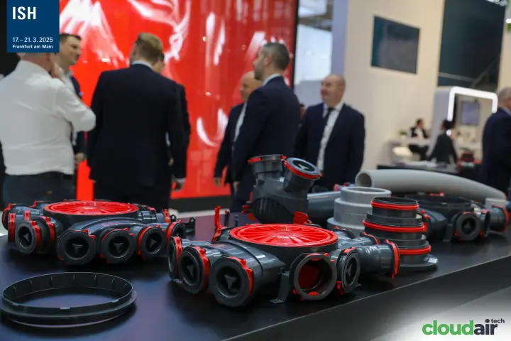 Ventilation fittings in front of a red video wall at the ARIA stand at ISH 2025