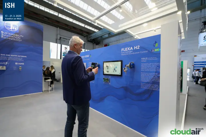 Visitor photographing the FLEXA H2 hydrogen combustion control display