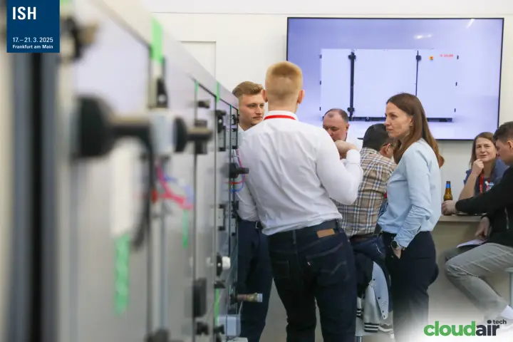 Visitors in conversation beside Salda air handling unit modules at ISH 2025