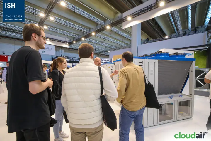 Visitors discussing an air-cooled chiller with blue fan housings at the Swegon stand at ISH 2025