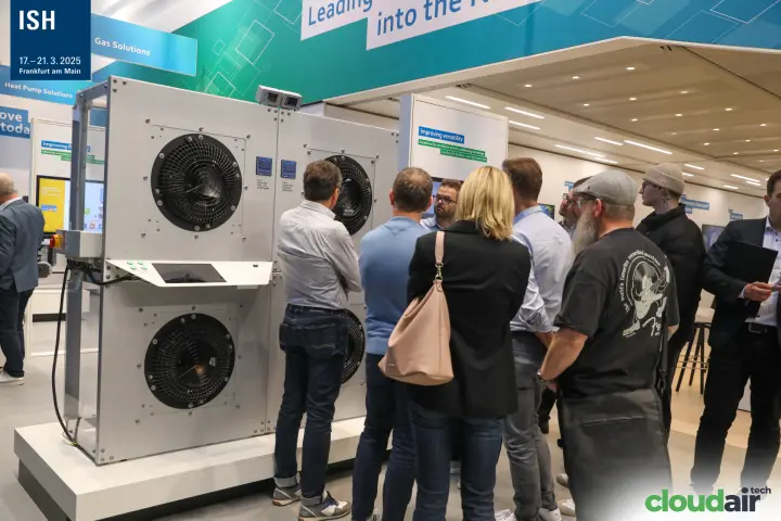 Visitors gather at an ebm-papst fan module wall with control panel at ISH 2025