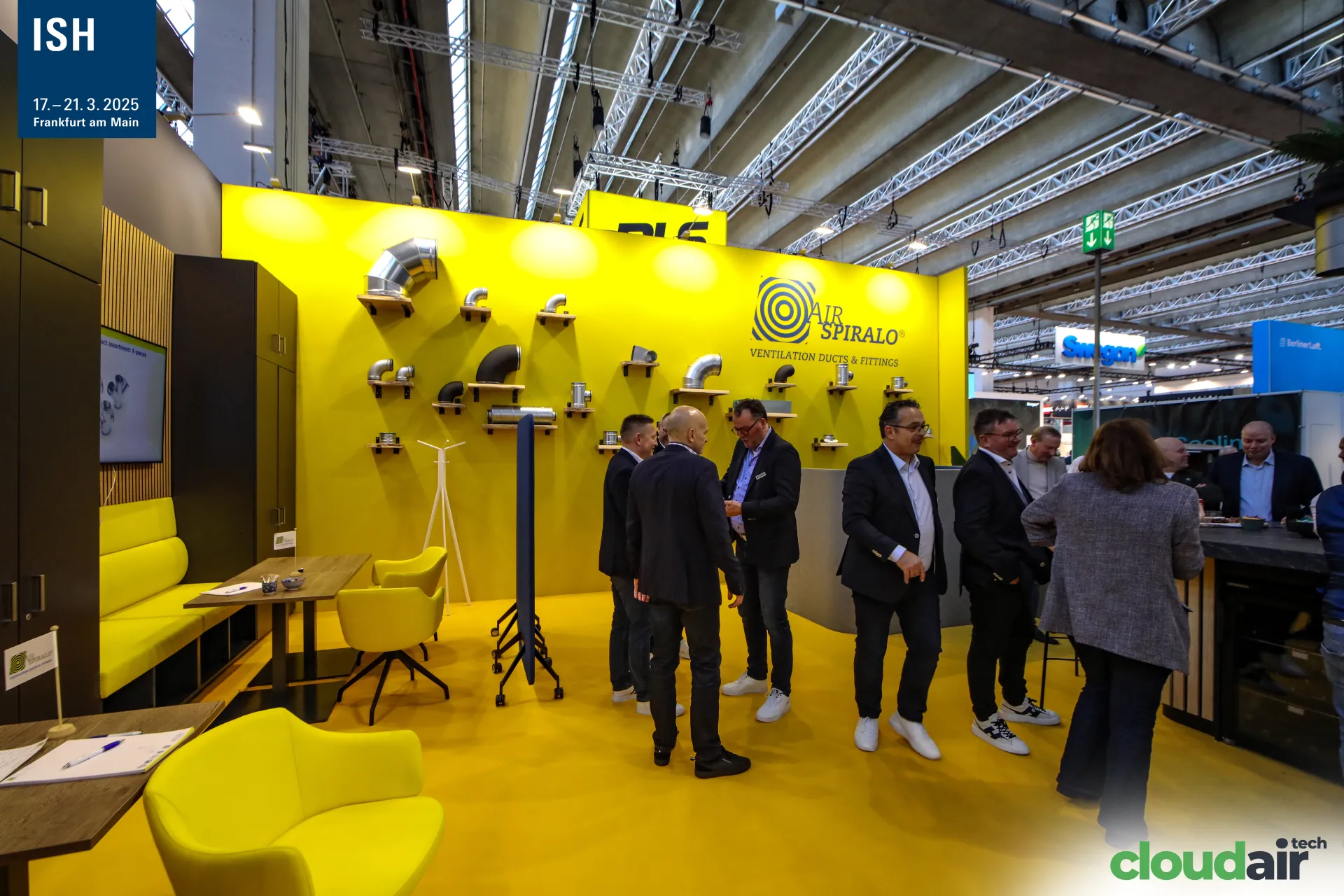 Visitors gather at the yellow Air Spiralo stand with duct fittings at ISH 2025