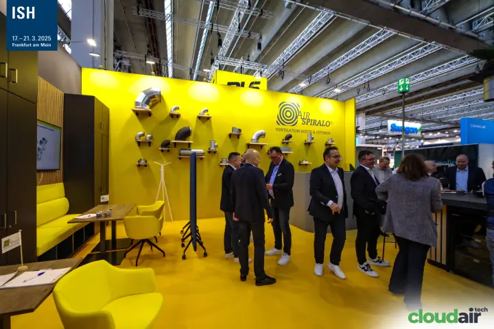 Visitors gather at the yellow Air Spiralo stand with duct fittings at ISH 2025
