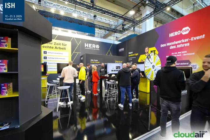 Visitors at the HERO software stand promoting HEROcon 2025