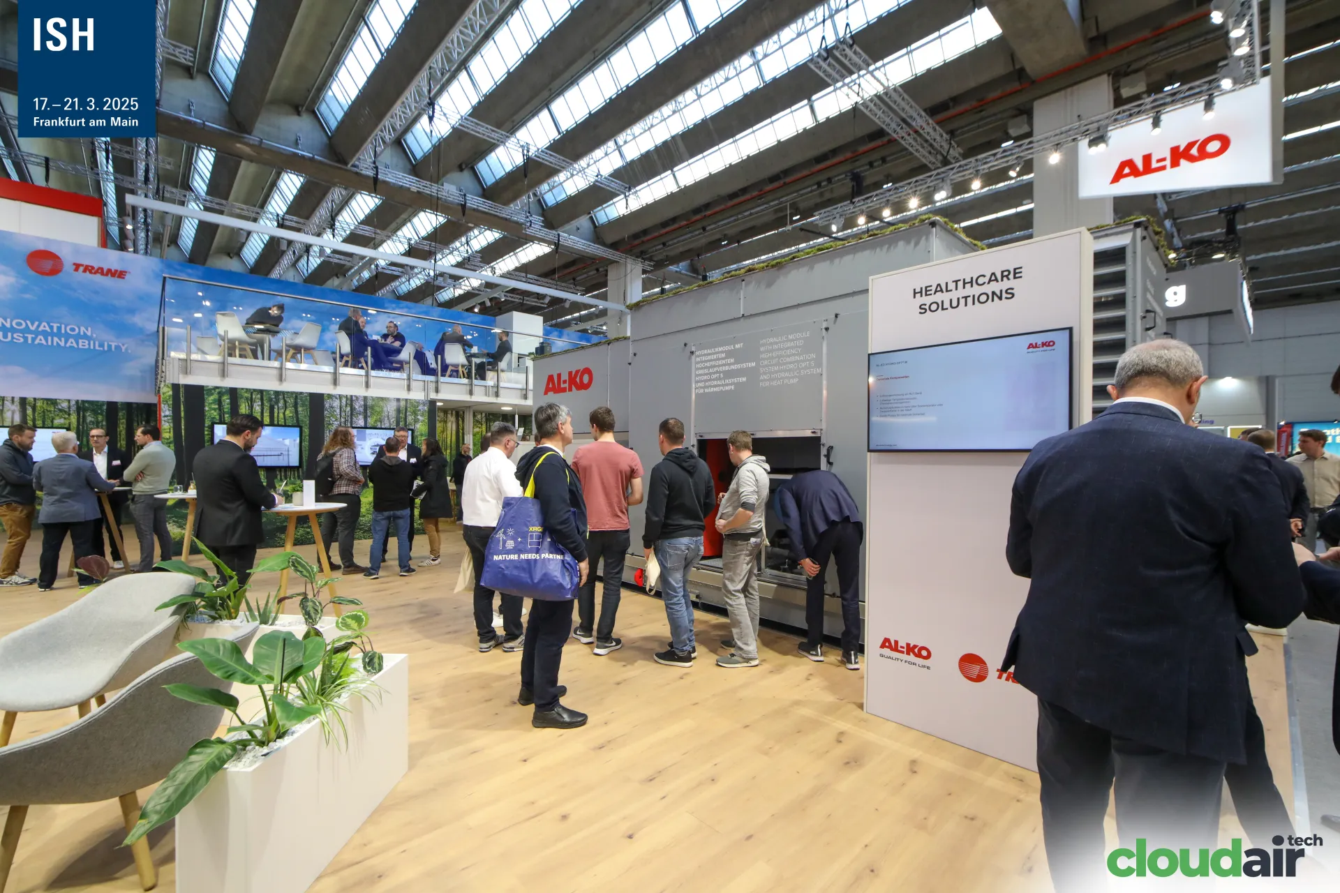 Visitors inspect a large AL-KO air handling unit at the stand at ISH 2025